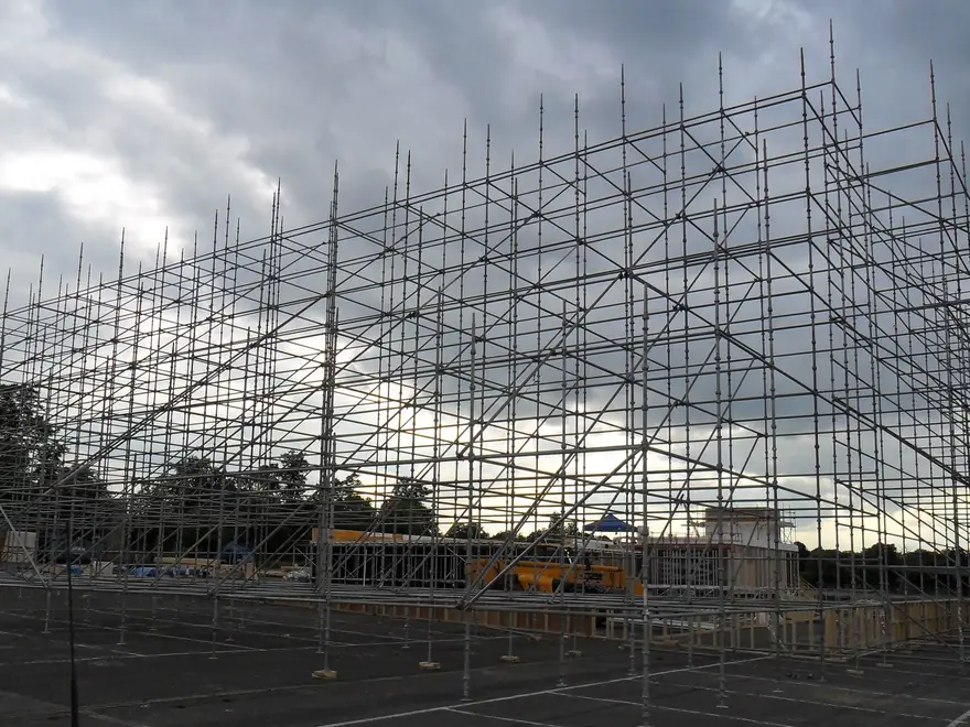 Rows of scaffold standards on base plates forming a free-standing film set frame in Aldershot