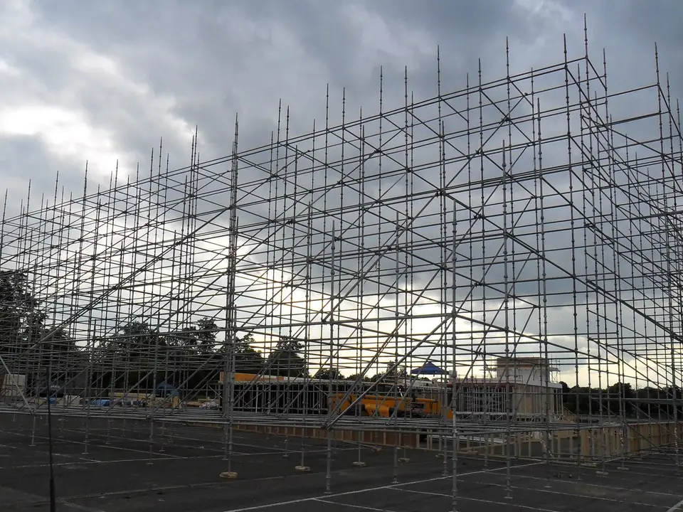 Rows of scaffold standards on base plates forming a free-standing film set frame in Aldershot