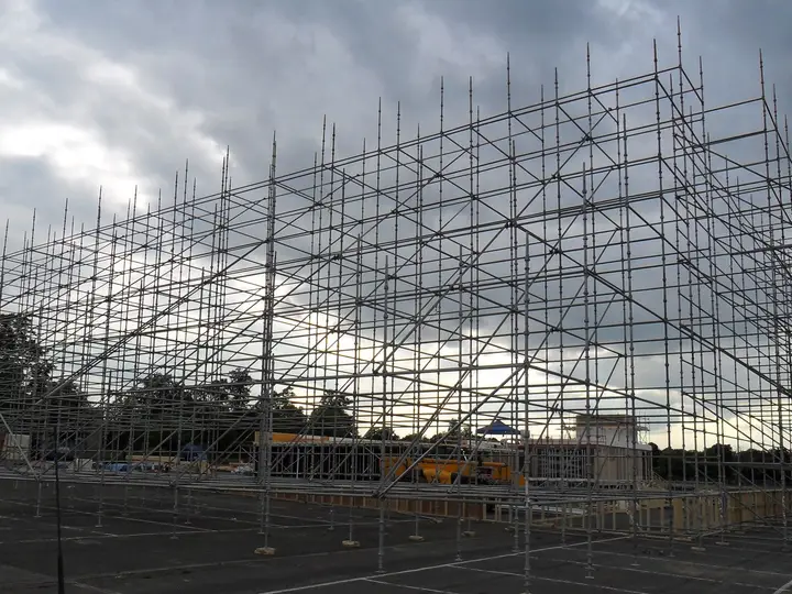 Rows of scaffold standards on base plates forming a free-standing film set frame in Aldershot