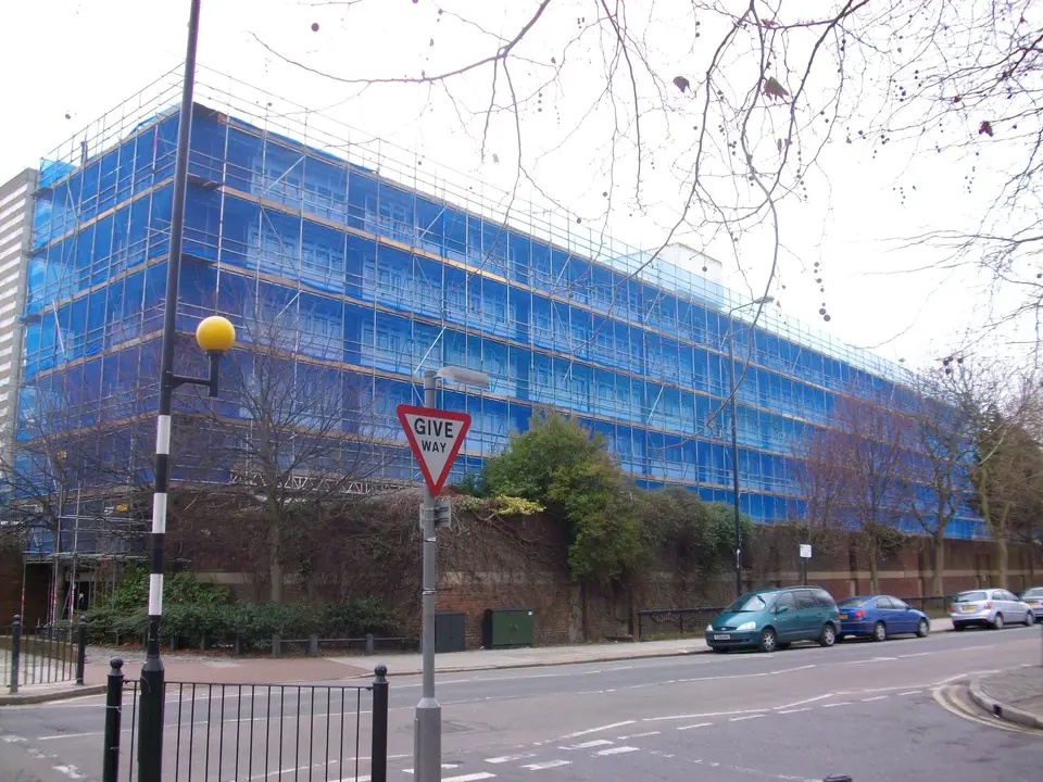 Fully netted scaffold along a multi-storey block in Basingstoke for recladding and new windows