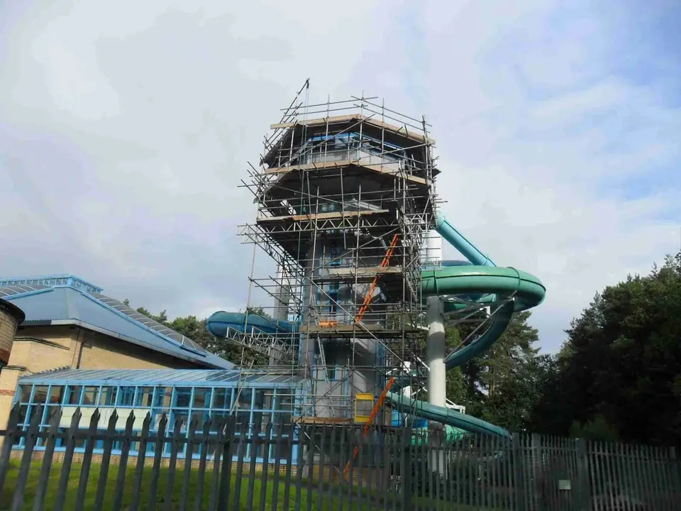 Scaffolded flume tower at Coral Reef Waterworld, Bracknell, beside the glazed pool hall