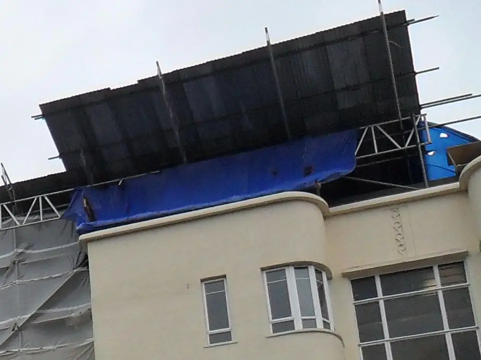 Trussed beams and roof sheets of a temporary roof on an apartment block in High Wycombe