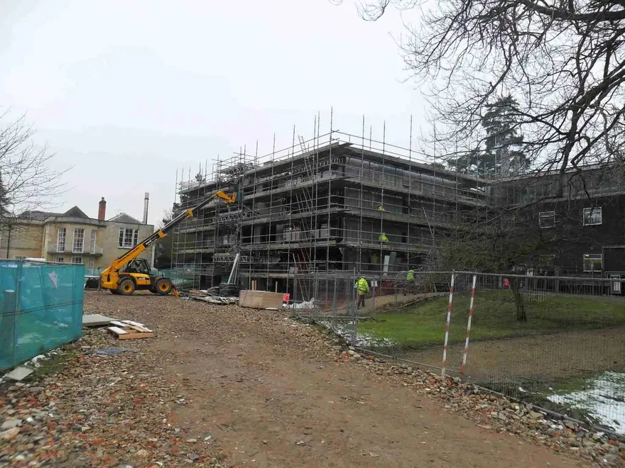Scaffolding on a new-build development with a telehandler working on site