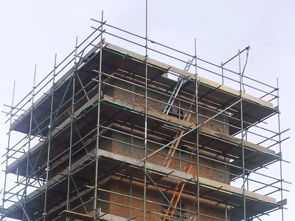 Top lifts of the scaffold on a Newbury church tower, with guardrails above the parapet