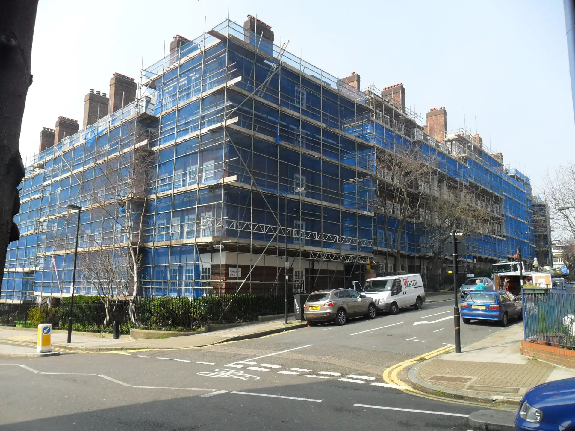 Netted scaffolding over a Kings Cross street elevation with a protected walkway