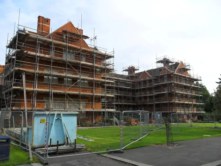 Scaffolding around red-brick Oxford college buildings during refurbishment