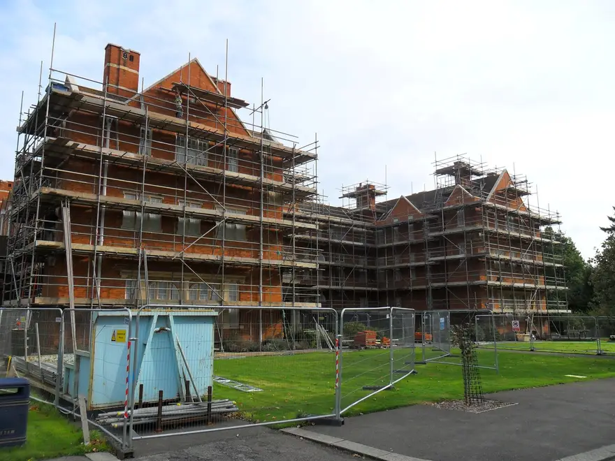 Scaffolding around red-brick Oxford college buildings during refurbishment