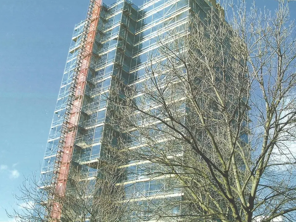 Scaffolded tower block in Slough with a construction hoist running up the side
